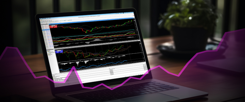 Primer plano de una pantalla de portátil que muestra gráficos de trading de forex, con una mano colocada sobre el teclado.