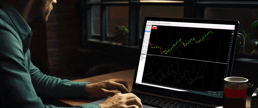 A man focused on his laptop, actively trading forex in a modern office setting.